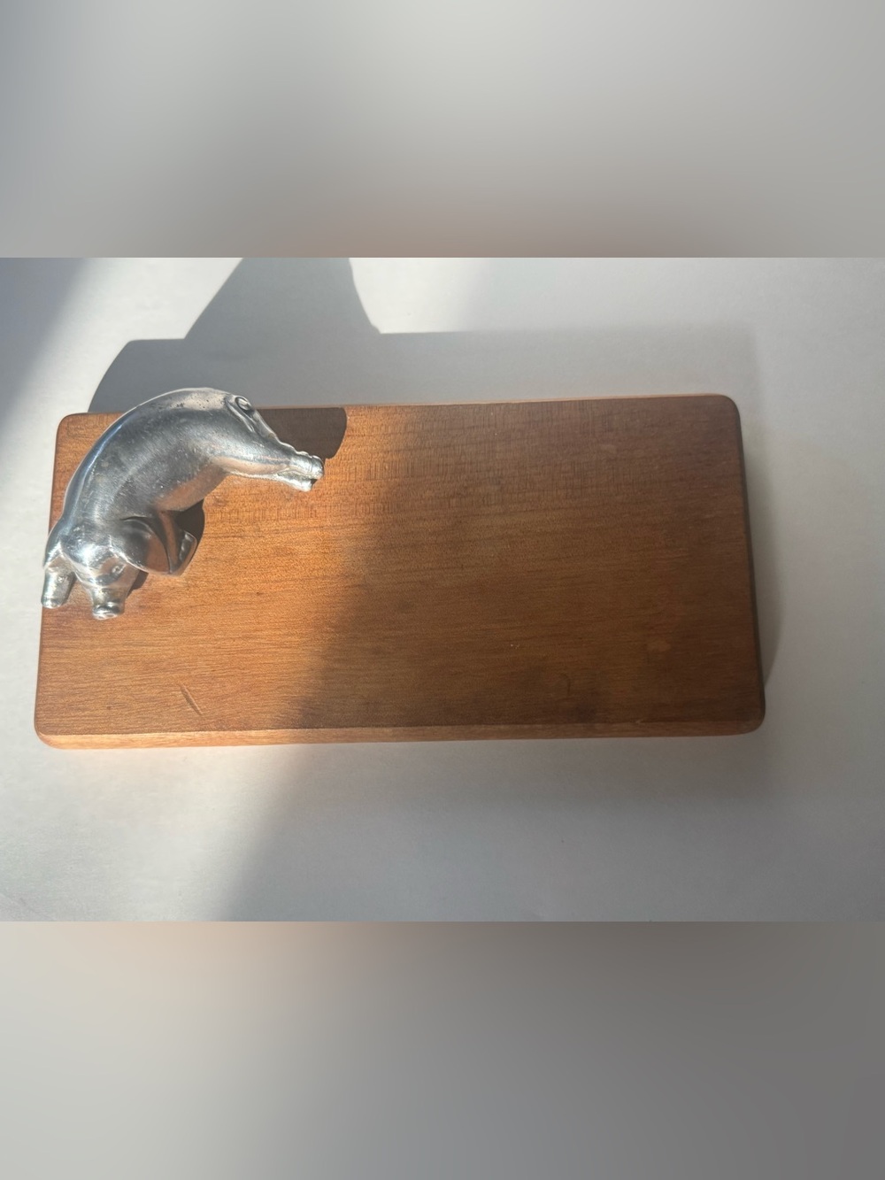 is a vintage wooden cutting or charcuterie